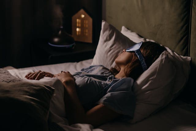 A woman sleeping with an eye mask